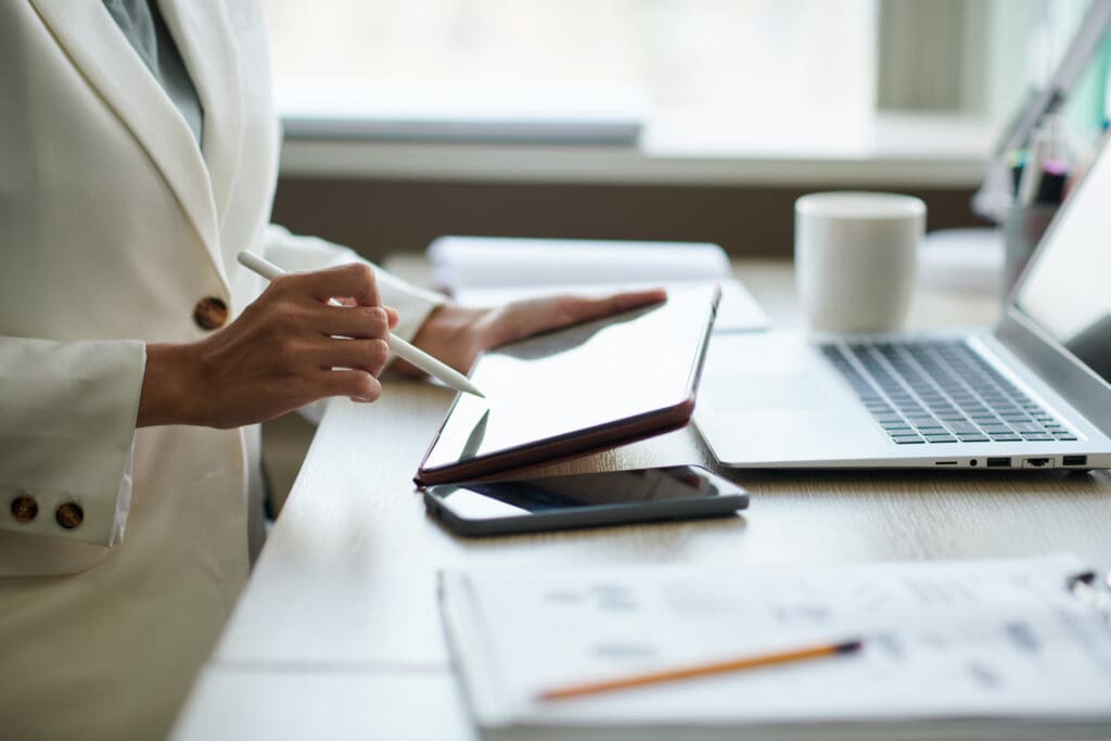 Image of woman reviewing documents on a tablet.