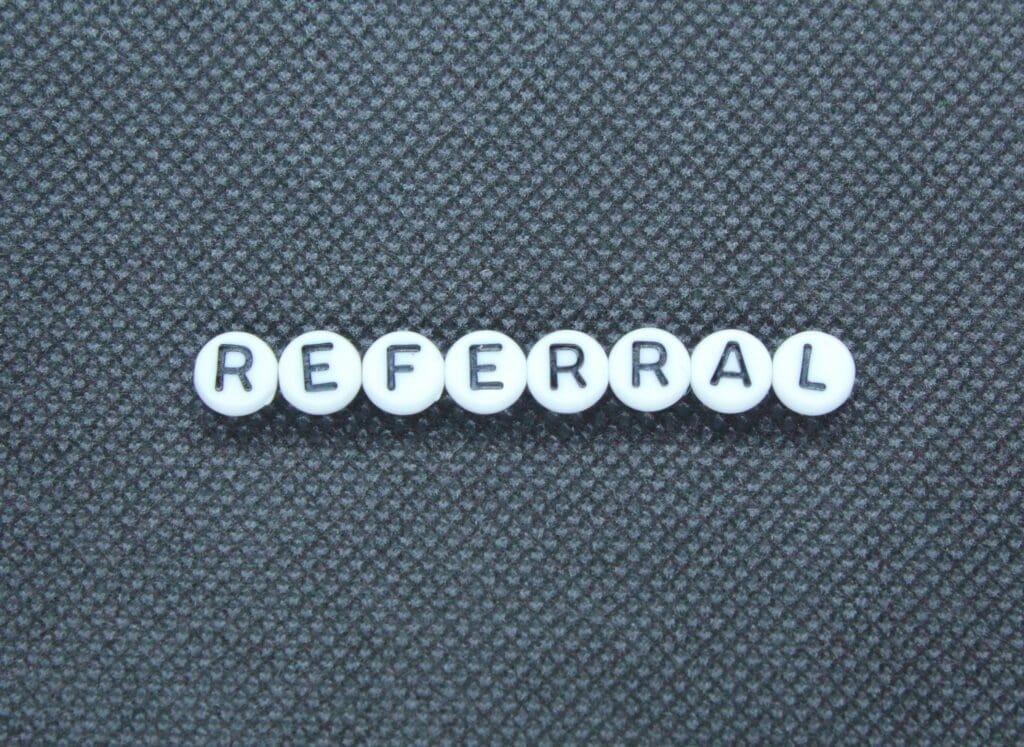 The Value of a Closing Gift. Word referral spelled out on blue background.