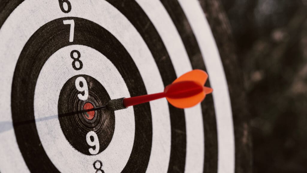Attract leads and boost success. Dartboard with arrow on center target. Concept of target audience
