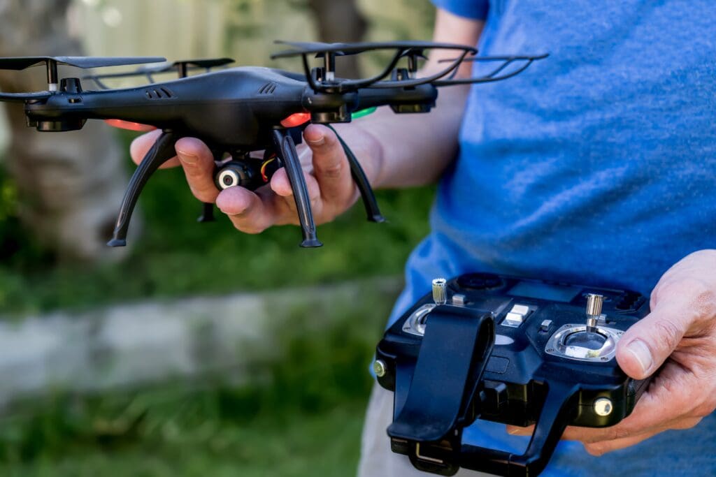 man-holding-camera-drone-and-the-remote-drone-pho-2022-11-15-14-05-14-utc - Real-Estate-Leads