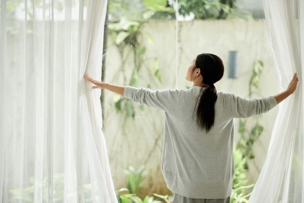 Woman Opening Curtains - Real-Estate-Leads Real Estate Photography and Visual Marketing: Proper Lighting