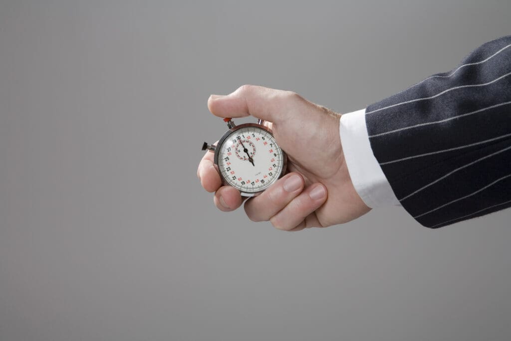 Man holding stop watch, close-up - Real-Estate-Leads Unlock Success with Our Expert Guide on Real Estate Copywriting: Sense of Urgency