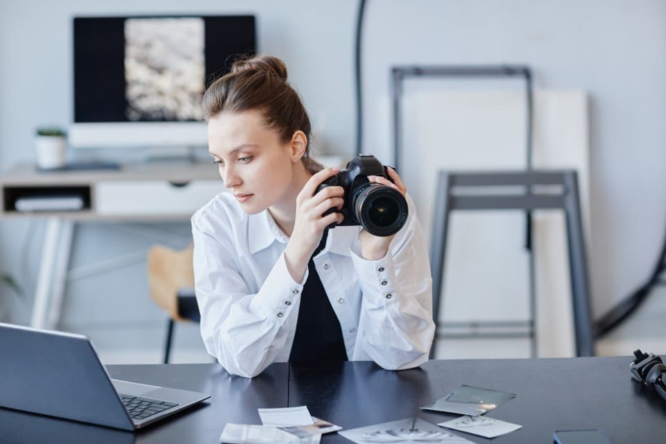 Female Photographer Editing Images - Real-Estate-Leads Honest Marketing Strategies: An Expert Guide for Real Estate Agents: Genuine Photos